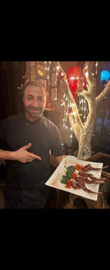 Chef 01 holding a plate of lamb chops