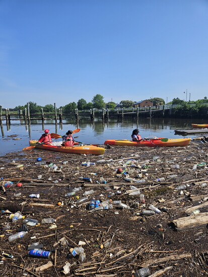 Chesapeake Conservation and Climate Corps member engaging faith-based organizations in environmental stewardship through a kayaking river cleanup event.