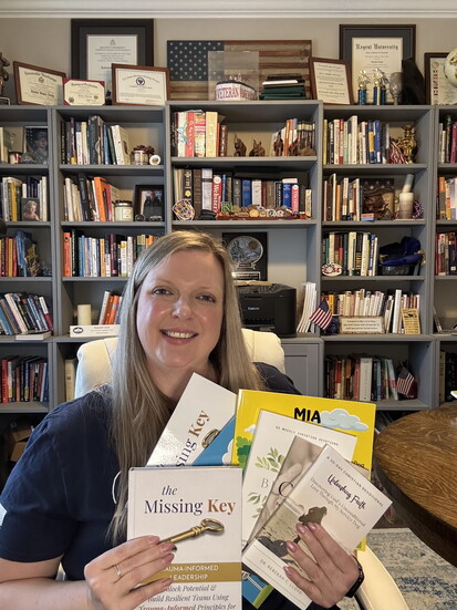 Dr. Rebekah Lloyd poses with her books.