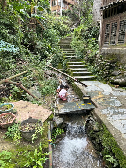 Village children play in a creek in Guangxi near the Longsheng Rice Terraces. 