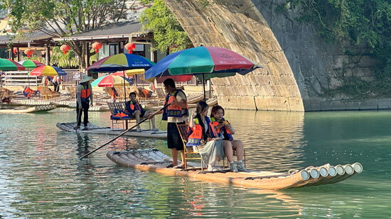 Bamboo rafts take passengers on a relaxing ride down the Yulong River in Yangshuo, Guangxi, Province. 