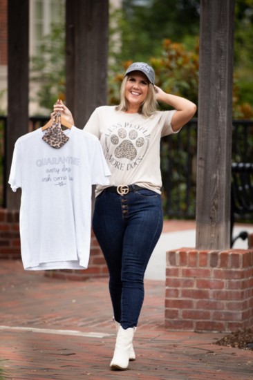Brittany Cox, owner of clothing boutique Southern Local, shows off two pieces from the Dog Mom collection.