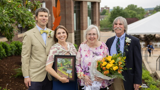 Sally Gross and family before the Doug & Sally Gross Memorial Garden that honors the memory of Doug Gross