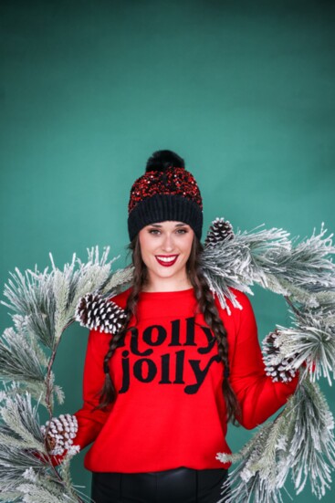 Black puffer vest by Mauritius.  Red “Holly Jolly” sentiment sweater.  Black faux leather jegging by RD International.