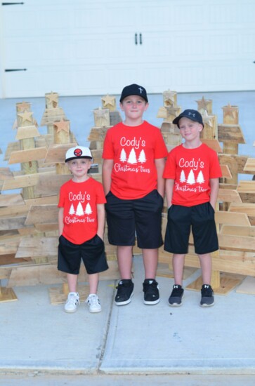 6. Bentley, Cody and Collin with their finished trees. The family works together to help improve the lives of shelter animals. 