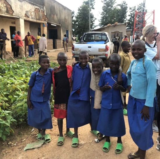 Children pose for a photo outside the Do Good Health Clinic in Rwanda