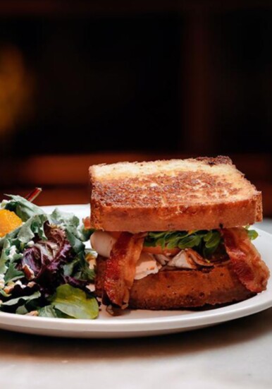 Gluten free turkey sandwich, turkey, bacon, arugula, tomato, avocado, side salad at Levure Bakery.