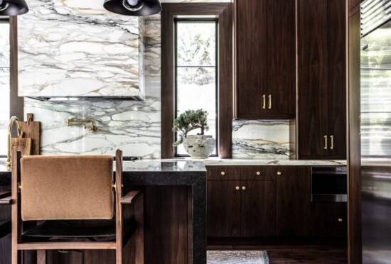 The kitchen features rich walnut cabinetry and Calacatta Paonazzo marble