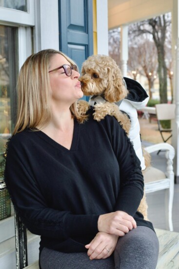 Blair Munger enjoys time with her pup at Harvest’s on-site coffee shop.