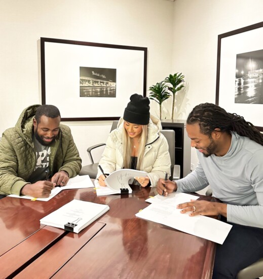 Kam Chancellor, Leilani Wong, and Richard Sherman sign a lease for Legion Sports Bar.