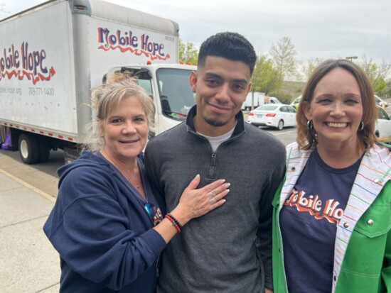 Donna Fortier, José Ayala, and Allyson Ruscitella distribute food on April 17 in Sterling then join in the Loudoun Hispanic Town Hall