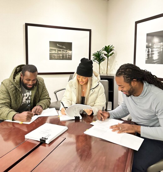 Kam Chancellor, Leilani Wong, and Richard Sherman sign a lease for Legion Sports Bar