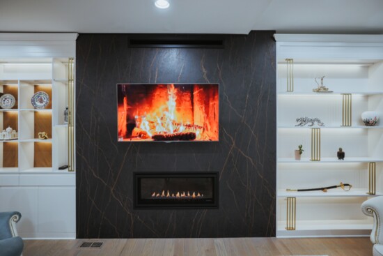 The top image is a wide-screen TV mounted above the real fireplace