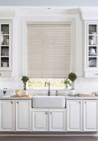 Faux wood blinds are budget-proof options—plus they can stand up to steam (e.g., pouring out pasta water in your sink) better than wood. 