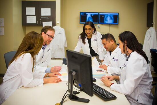 Lone Star medical residents collaborate on patient care planning during clinical training in Conroe.