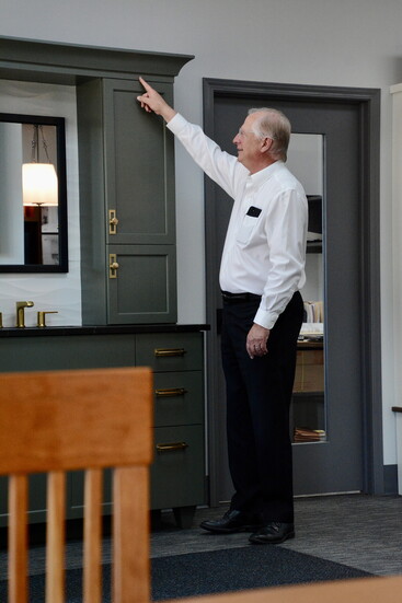 Allen Curran noting a distinguishing cabinetry feature in their showroom on High Point Road.