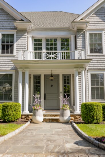 Two large and gorgeous urns grace the front of this beautiful local home.
