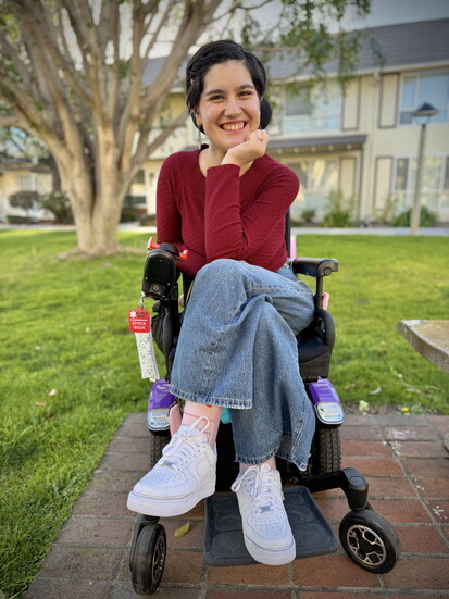 LuLu, a wheelchair and AFO user with her accessible Nike Air Force Ones