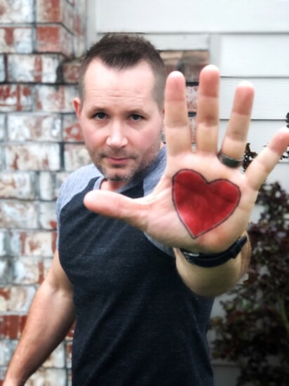 In a presentation on child abuse, Corbin wore his heart on his hand, signifying if his hands don't follow his heart, nothing will be accomplished