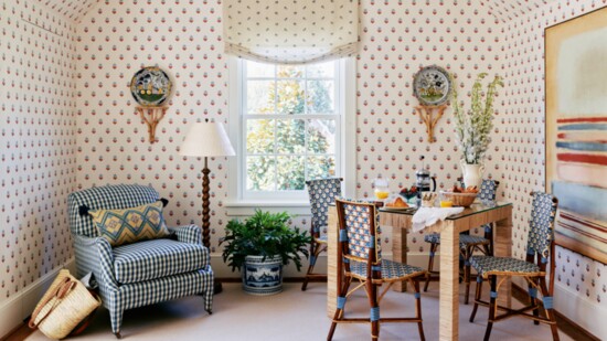 “Indian Tulips” wallpaper by Ottoline swathes the walls in the breakfast nook. Antique polychrome Delft plates from Kim Faison Antiques rest atop brackets found