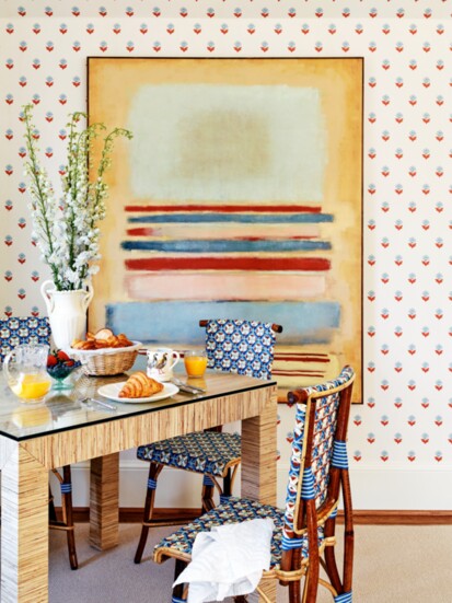 An abstract painting by Diane Lightsey imbues color and style in the breakfast nook, where a flower-filled Frances Palmer vase accents a Villa & House table.