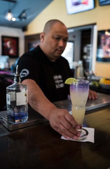 Bar leader Mario Wongsosudiro serves up a fresh cocktail. 