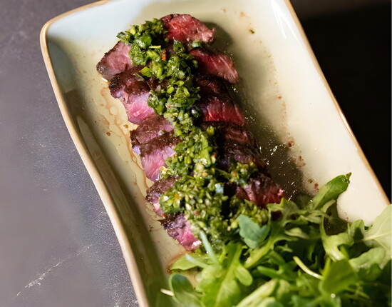 Delicious eats at Georgia’s include Prime New York steak served with an arugula mix and chimichurri.