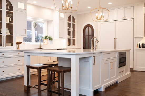 Unique features include a large central island for prep and gathering, an arched pantry entry, layered, dimmable lighting and floor-to-ceiling cabinetry. 