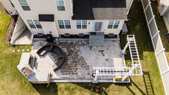 This revitalized outdoor space features expert tiling, integrated steps, and a custom fireplace to restore functionality and style.