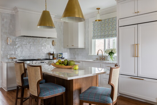 The kitchen backsplash is a handmade mosaic by Surface Studio, formerly known as Palmetto Tile. The Goodman pendant lighting over the island by Visual Comfort 