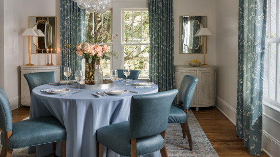 Custom, functioning drapery panels in Carolina Irving’s Mimosa fabric bring tailored elegance to the dining room