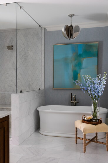A polished-nickel Danes chandelier by Visual Comfort shines over the tub, paired with art from Wendover Art Group