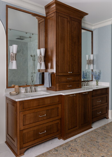 They opened the primary bath for a lighter, brighter, and more functional space. Utopia sconces from Visual Comfort add artistry and practicality, casting light