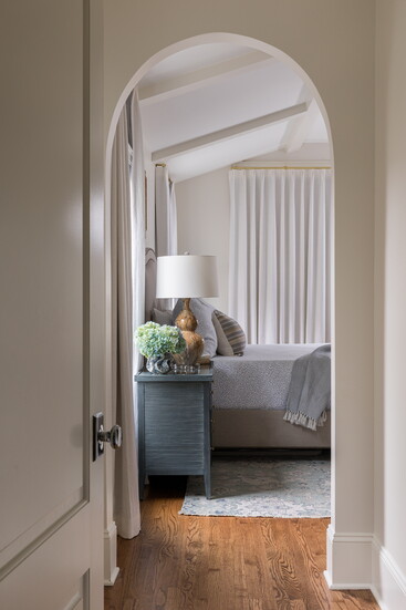 Cooler colors continue into the primary suite, where the homeowners wanted a relaxing and calm feel