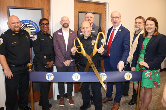 Kristen stands far right with Chamblee officials at a recent ribbon cutting.