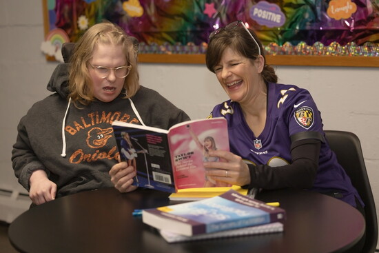 Joy Barton at Harford Center reading with a participant. Photo Credit: Kerry Paradis Photography