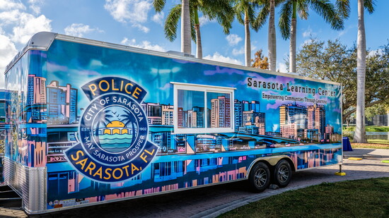 Walsh’s “Skyline of Sarasota, Florida” is reimagined in a bright, comic-style wrap spanning the 28-foot Sarasota Learning Center.