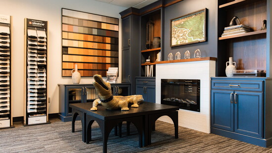 Cabinet color options on display behind a gold alligator centerpiece 