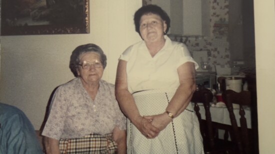 Omie Neal and Violet Neal, my great-grandmother and grandmother, don their aprons after cooking.