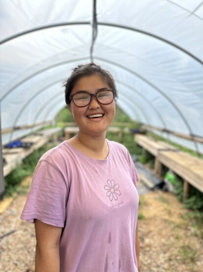 Youth food justice intern in the Hoop House at CHS. Photo credit: Aleen Carey