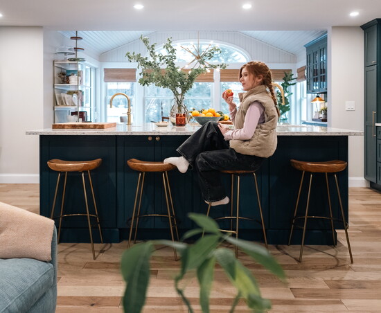 Mira Elsemore enjoys a snack in her family's newly designed living space.