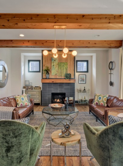 A striking fireplace and wood beams define the living room.