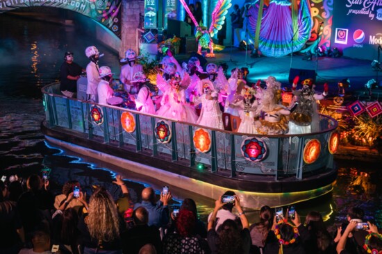 Thousands of people line the River Walk to watch the Dia de los Muertos parade (Credit: Visit San Antonio)