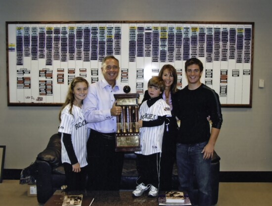 Dan’s office at the Colorado Rockies' stadium with the World Series trophy and his family.