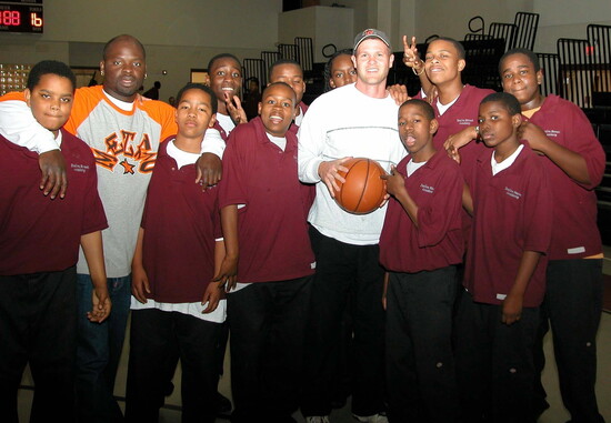 With the basketball team, sharing lessons of teamwork and leadership.