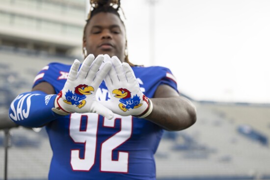 KU DL Tommy Dunn, Jr. shows the gloves he wears in games