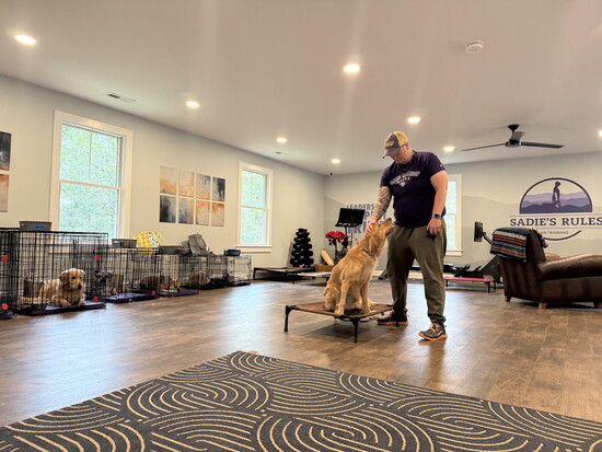 Jess Schneiderman with a dog. Photo Credit: David Withers
