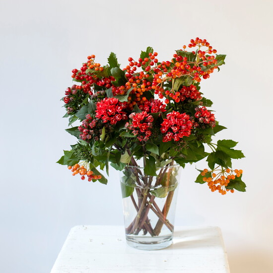 Hypericum and hawthorn flowers in a vase.