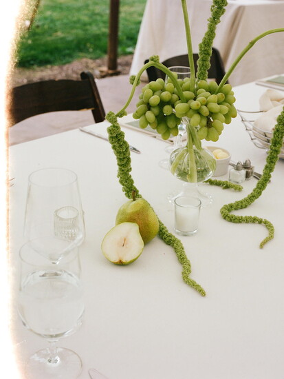 Tablescape with grapes and flowers. Photo Credit: Josephine Manet Photography