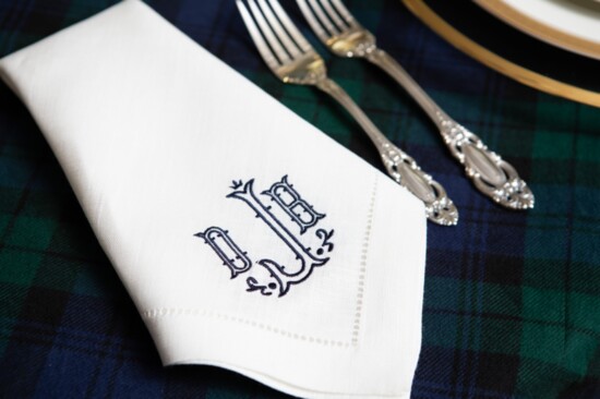 Pressed linen napkins monogrammed in navy with Dianes’ initials 